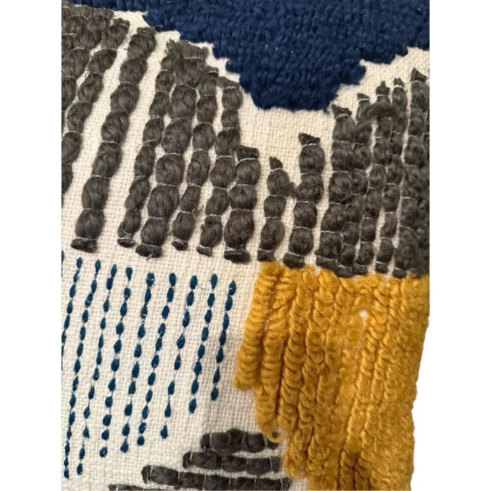 Pier 1 square boho embroidered blue, grey, and yellow decorative pillow.